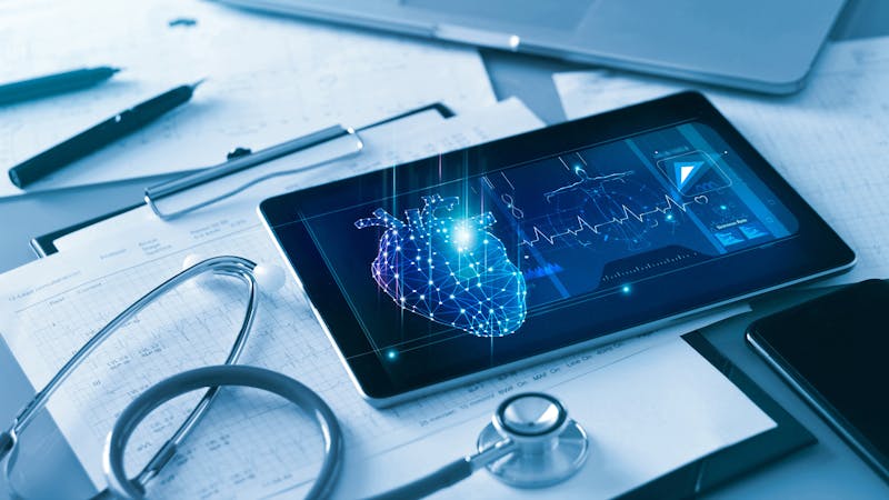 Technology and healthcare, Doctor’s cardiologist tablet and heart disease health care analysis data on screen and stethoscope with report heartbeat on table.
