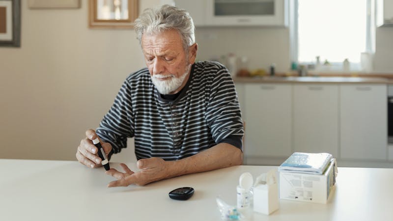 Senior man with glucometer