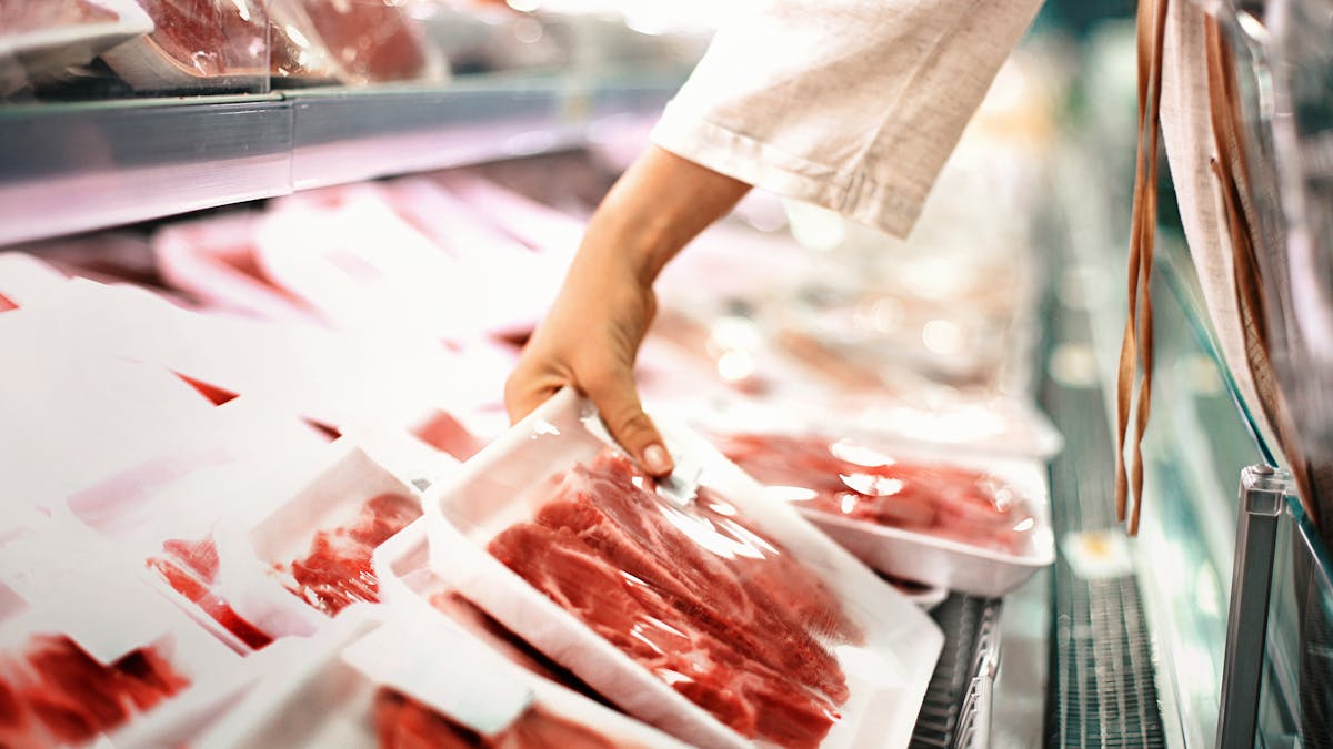 Buying meat at a supermarket.