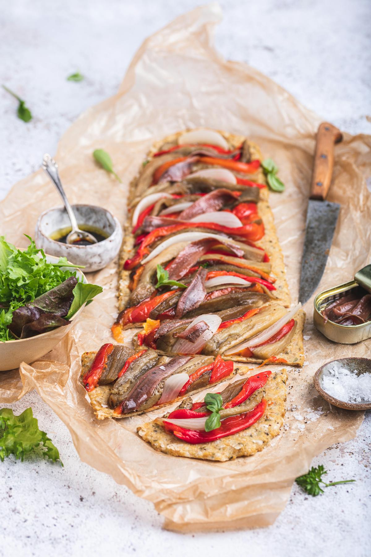 Mediterranean high protein pizza with roasted vegetables and anchovies