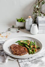 Sirloin steak with butter-fried green beans and almonds