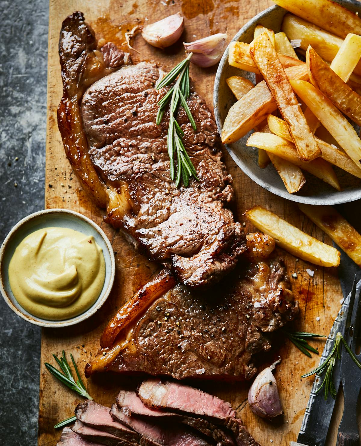Steak, chips with garlic, and rosemary butter