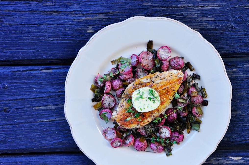 Oven-baked chicken breast and radishes with thyme butter