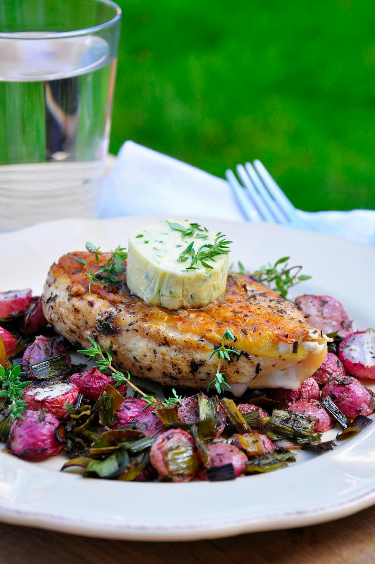 Oven-baked chicken breast and radishes with thyme butter