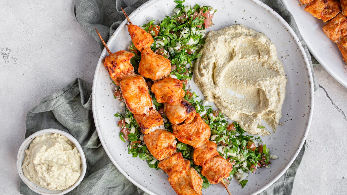 Chicken skewers with low carb tabouleh and hummus