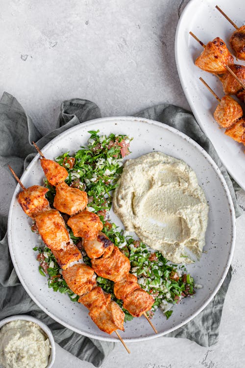 Chicken skewers with low carb tabouleh and hummus