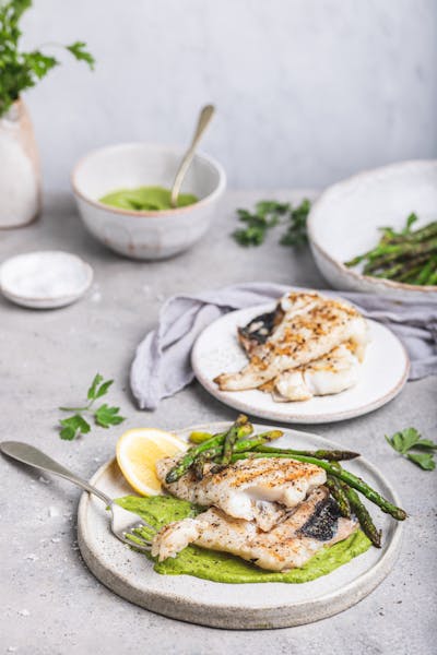 Hake fish in green sauce with asparagus