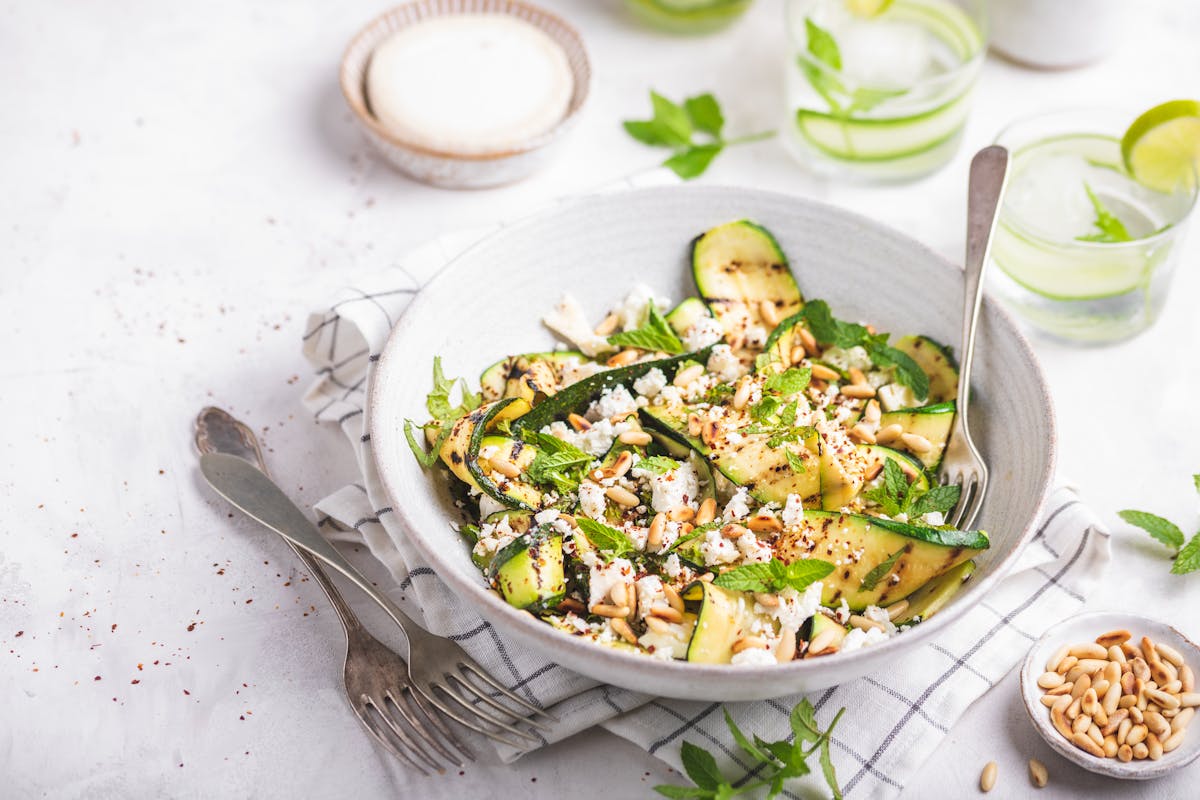 Grilled zucchini salad with goat cheese, pine nuts, and mint