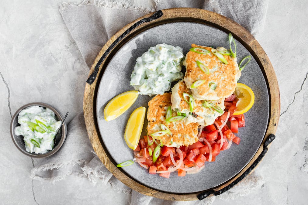 Keto chicken fritters with avocado tzatziki and tomato salad