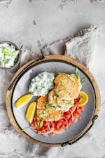 Keto chicken fritters with avocado tzatziki and tomato salad
