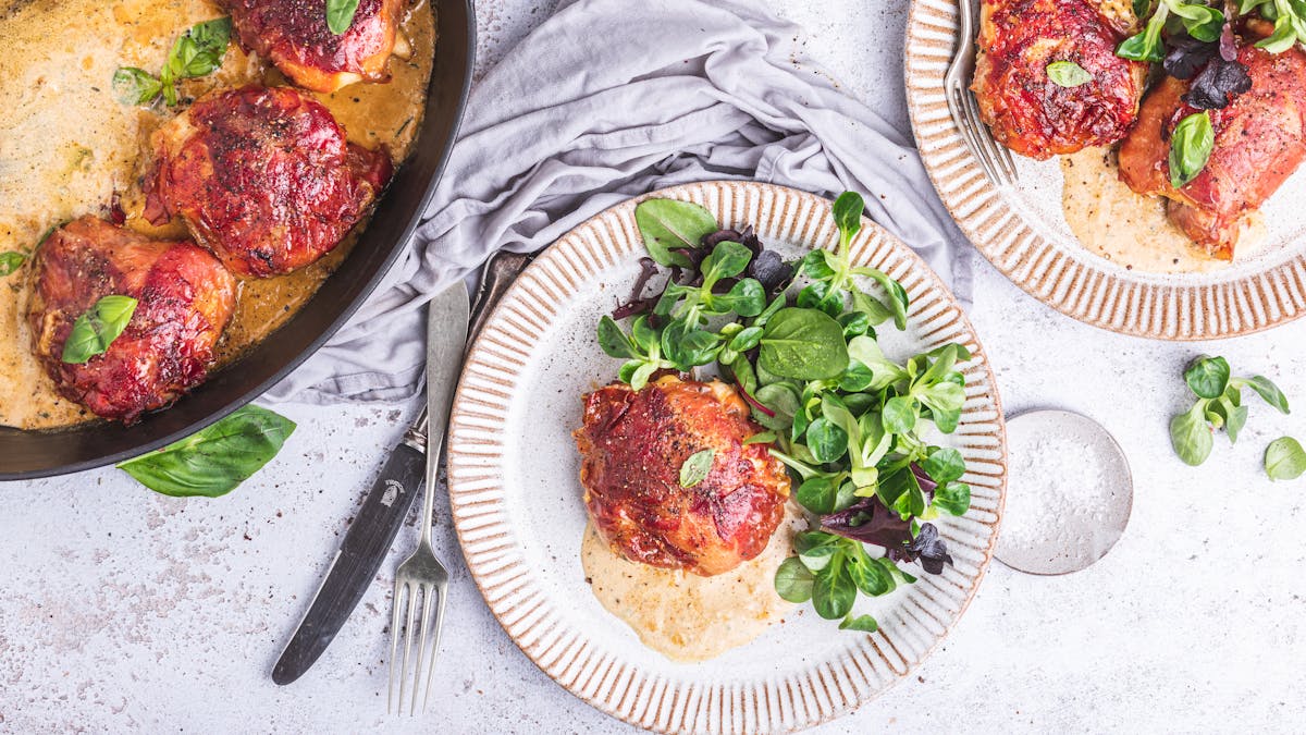 Prosciutto-wrapped chicken thighs with garlic cream sauce