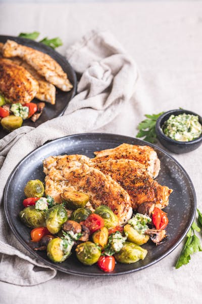 Chicken breast with roasted vegetables and garlic butter