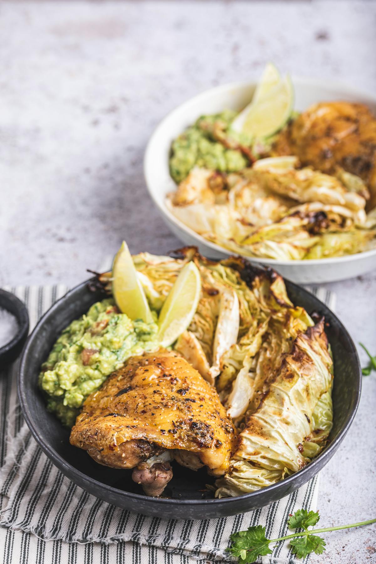 Baked chicken thighs with guacamole and roasted cabbage