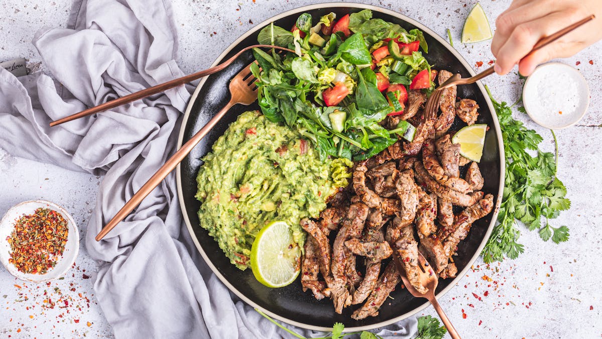 Mexican steak strips with salad and guacamole