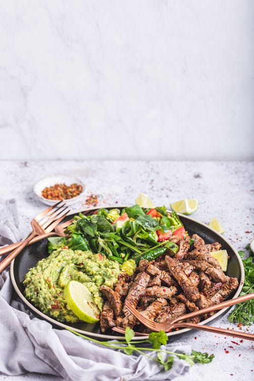 Mexican steak strips with salad and guacamole