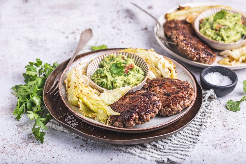 Smash burger with guacamole and roasted cabbage