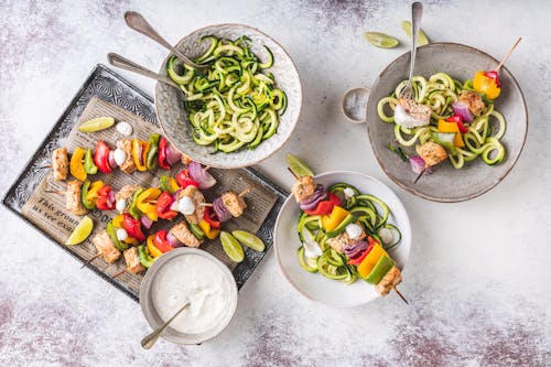 Rainbow cajun salmon skewers with zoodles & garlic lime sauce