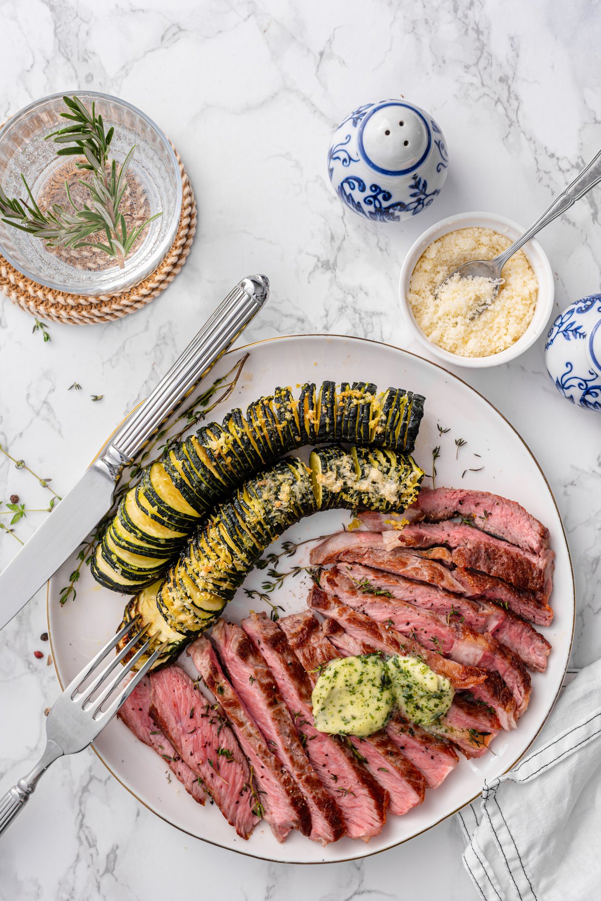 Ribeye with Hasselback zucchini and herb butter