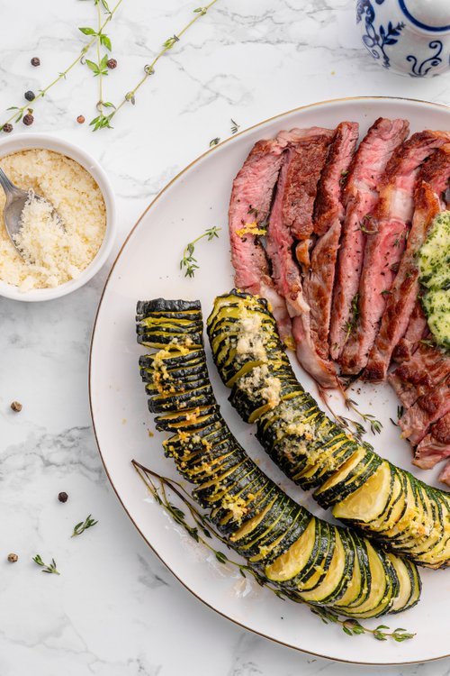 Ribeye with Hasselback zucchini and herb butter