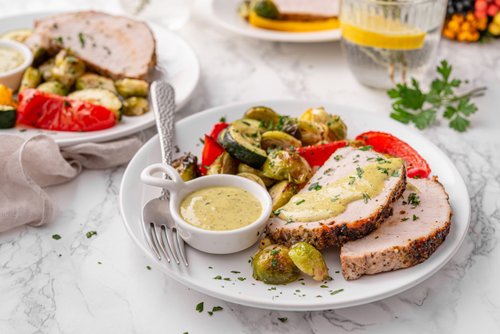 Pork tenderloin with roasted vegetables and pesto aioli