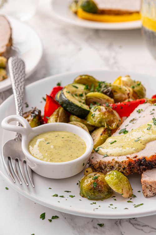 Pork tenderloin with roasted vegetables and pesto aioli